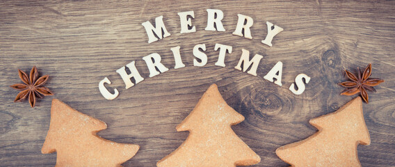 Vintage photo, Inscription Merry Christmas with homemade gingerbreads and cookies for festive time