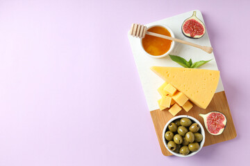 Concept of cooking eating with hard cheese on purple background