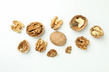 Walnuts with nutshell on white background, top view
