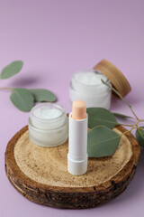 Concept of face care cosmetic on violet background