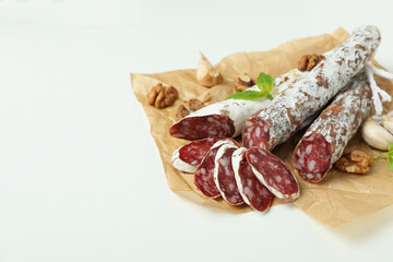 Сoncept of tasty food with salami sausage on white background