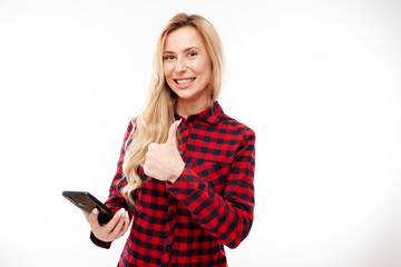 Naklejka premium Beautiful blonde girl in casual showing blank phone screen thumbs up and smiling isolated on white studio background