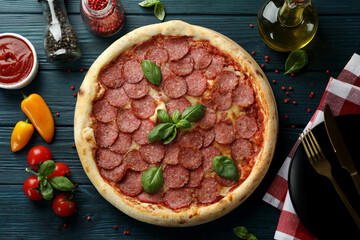 Concept of tasty food with Salami pizza on wooden table