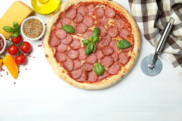 Concept of tasty food with Salami pizza on white wooden background