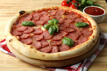 Concept of tasty food with Salami pizza on wooden background