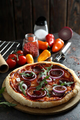 Concept of tasty food with Salami pizza on dark table