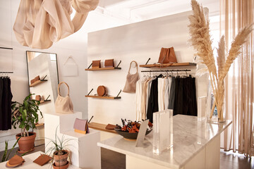 Interior of stylish clothing shop with accessories on display