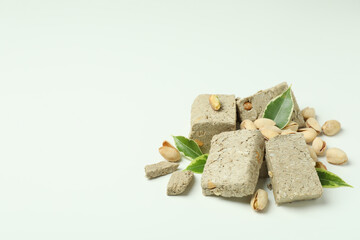 Halva with pistachio and leaves on white background