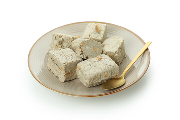 Plate with halva and spoon isolated on white background