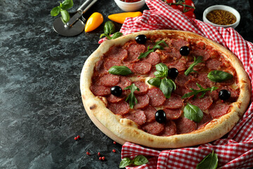 Concept of tasty food with Salami pizza on dark background