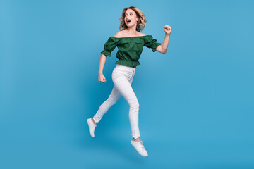 Fototapeta na wymiar Profile photo of lady jump run look back empty space wear bear shoulders green blouse isolated blue color background