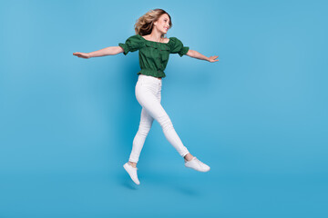 Fototapeta na wymiar Profile photo of inspired lady jump go wear bear shoulders green blouse pants shoes isolated blue color background