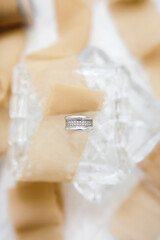 Jewelry, white gold ring with diamonds, close-up. Selective focus. Vertical photo.