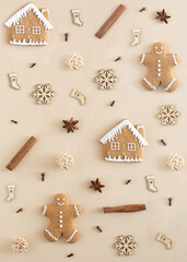 Minimal nature winter concept. Creative Christmas layout made with gingerbread cookies, house, cinnamon, star anise, cloves, snowflakes and socks.