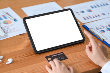 Fototapeta premium Close-up image of woman hands using tablet blank white screen and holding credit card. Online shopping concept.