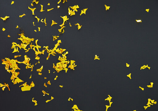 Sparkle golden confetti on a black background
