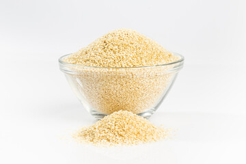 Raw seeds in a glass bowl isolated on white background.