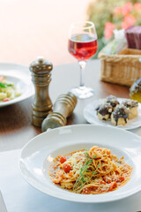 Spaghetti pasta with tomatoes and shrimps in a restaurant of italian food