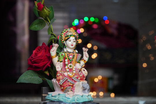 laxmi devi wallpaper with red rose image HD
