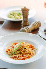 Spaghetti pasta with tomatoes and shrimps in a restaurant of italian food