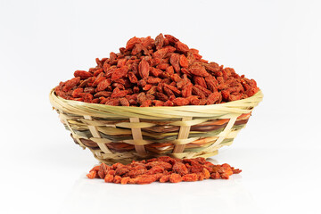 Goja berries in a wicker bowl isolated on white © Victoria