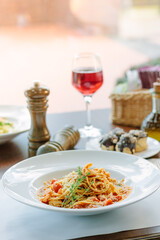Spaghetti pasta with tomatoes and shrimps in a restaurant of italian food
