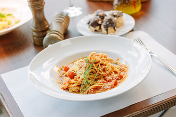 Spaghetti pasta with tomatoes and shrimps in a restaurant of italian food
