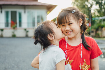 People portrait of an emotional face expression of smiling and happy of sisters 6 year old Asian sibling kids. Family healthy and happiness children and love concept.
