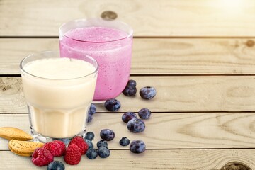 Tasty milkshake with blueberries in a glass on  background. Healthy dessert