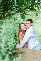 Young couple falling in love with each other on a green park