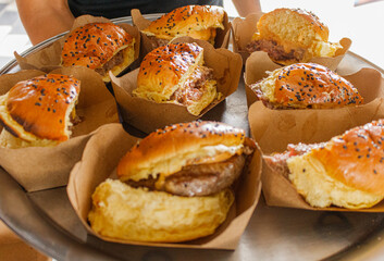 a lot of hamburger cutted of on paperboard plates