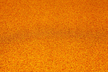 Fototapeta premium Golden shiny texture. Selective focus of orange tone gold glitter. Gold sparkle background. Design element for wedding, Christmas and New Year invitation. Celebration and luxury concept.