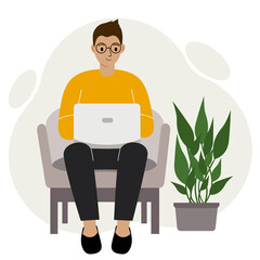 A man sits with a laptop on an armchair at home. I work on a computer. Freelance, online education or social media concept.