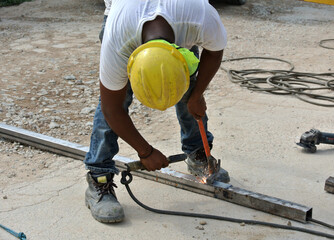 SELANGOR, MALAYSIA -DECEMBER 09, 2015: Welder wearing protective mask welding metal at the construction site. 