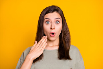 Portrait of young shocked amazed surprised girl hear unbelievable information gossip isolated on yellow color background