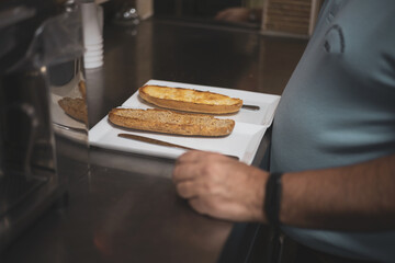 a waiter preparing two toasts in a bar.