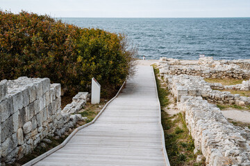 Seascape. Descent to the sea. Wooden descent going to the very edge of the shore. Tides, sea waves....