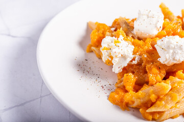 Pasta with pumpkin and goat cheese. Autumnal pasta with pumpkin.