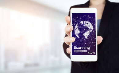Rule the world, world domination concepts. Hand hold white smartphone with digital hologram world, earth, map, globe sign on light blurred background. Global world telecommunication network