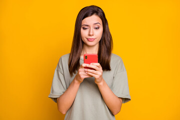 Portrait of pretty skeptic focused brown-haired girl using device browsing news comment isolated...