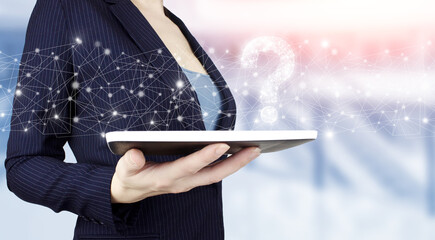 FAQ frequently asked questions concept. Hand hold white tablet with digital hologram question mark...