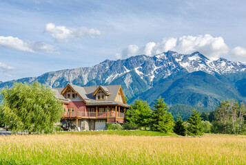 Luxury house over fantastic mountain view at sunny day in Vancouver, Canada.