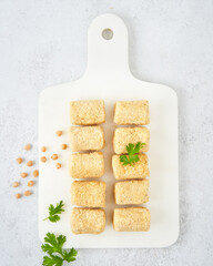 Raw vegetarian gluten free croquettes made with chickpeas. A nutritious vegan starter. Meat alternative Vegetarian Food delivery concept.