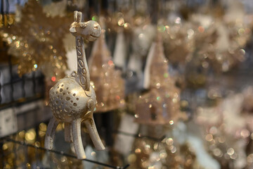 Traditional Christmas market with souvenirs. Decor market. New Year's toy giraffe in the store. Christmas shopping for the New Year tree.