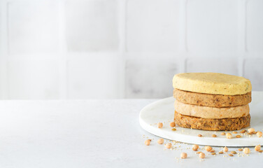 Various raw meat free plant based burgers, veggie legumes patties, quinoa, chickpeas, beans lentils, light background. Vegetarian food concept. Macrobiotic diet. Gluten free.