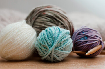Fototapeta na wymiar The yarn is white, blue and brown. Balls of yarn close up.