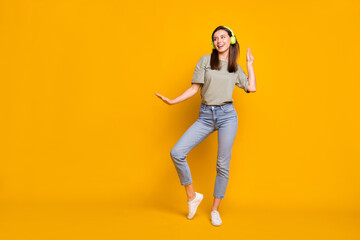 Fototapeta na wymiar Full length body size view of pretty carefree cheerful girl listening melody dancing rest isolated over bright yellow color background