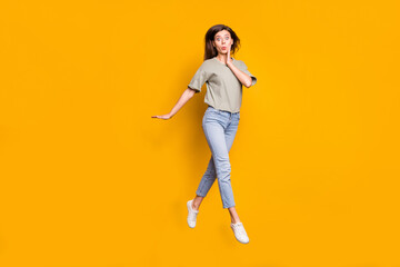 Fototapeta na wymiar Full size photo of young amazed surprised shocked girl jumping pout lips hold hand cheek isolated on yellow color background