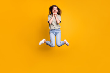 Fototapeta na wymiar Full length body size view of lovely funny cheerful girl jumping having fun great news isolated over bright yellow color background