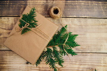 Boxes packed with kraft paper and natural twine on a wooden background.The concept of Christmas and New Year.